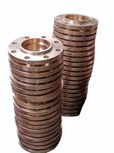 Stacks of machined copper alloy flanges ready for dimensional inspection and export packing: bronze flange exporter India