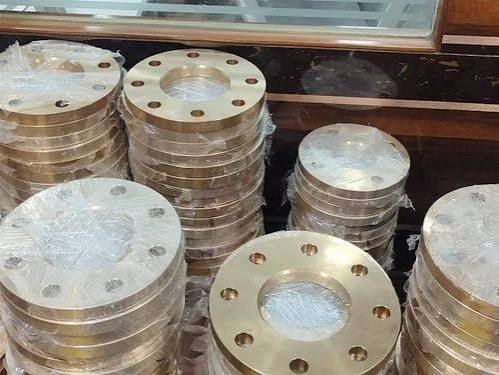 Machined bronze and copper alloy plate flanges stacked for final inspection: bronze flanges quality control and inspection