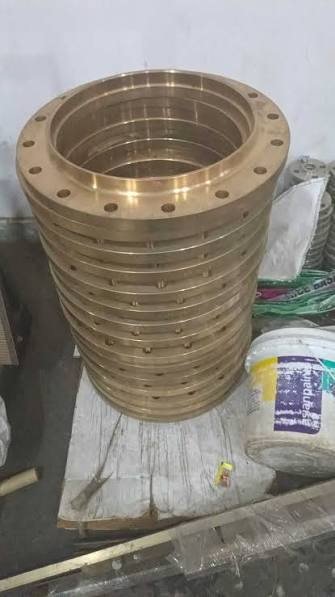 Stack of machined bronze flanges: UNS C63000 aluminium bronze flanges manufacturer and exporter, wrought bar and forging stock